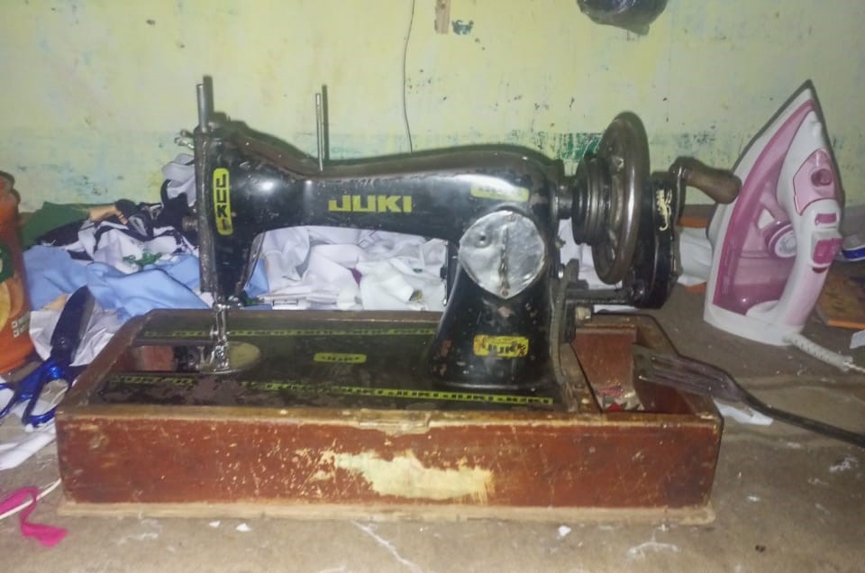 A hand operated sewing machine.